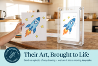 Child's rocket drawing next to the Little Picasso Frame playing the animated rocket